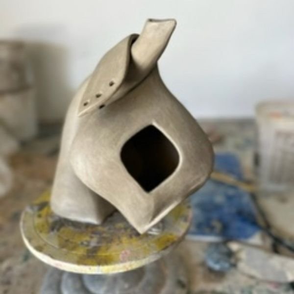 Adult hand-building a pottery piece during class at The Pottery Outpost in San Diego.