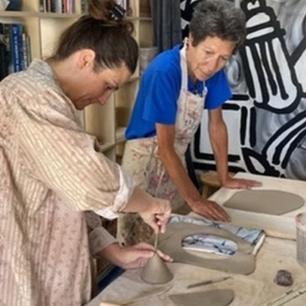 Clay hand-building session with adult students in San Diego pottery studio.