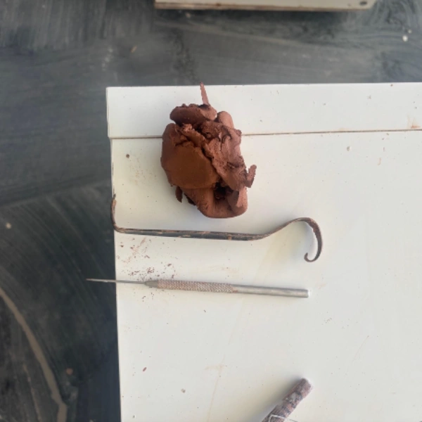 Pottery trimming tools and clay keys prepared for trimming a bowl on the wheel
